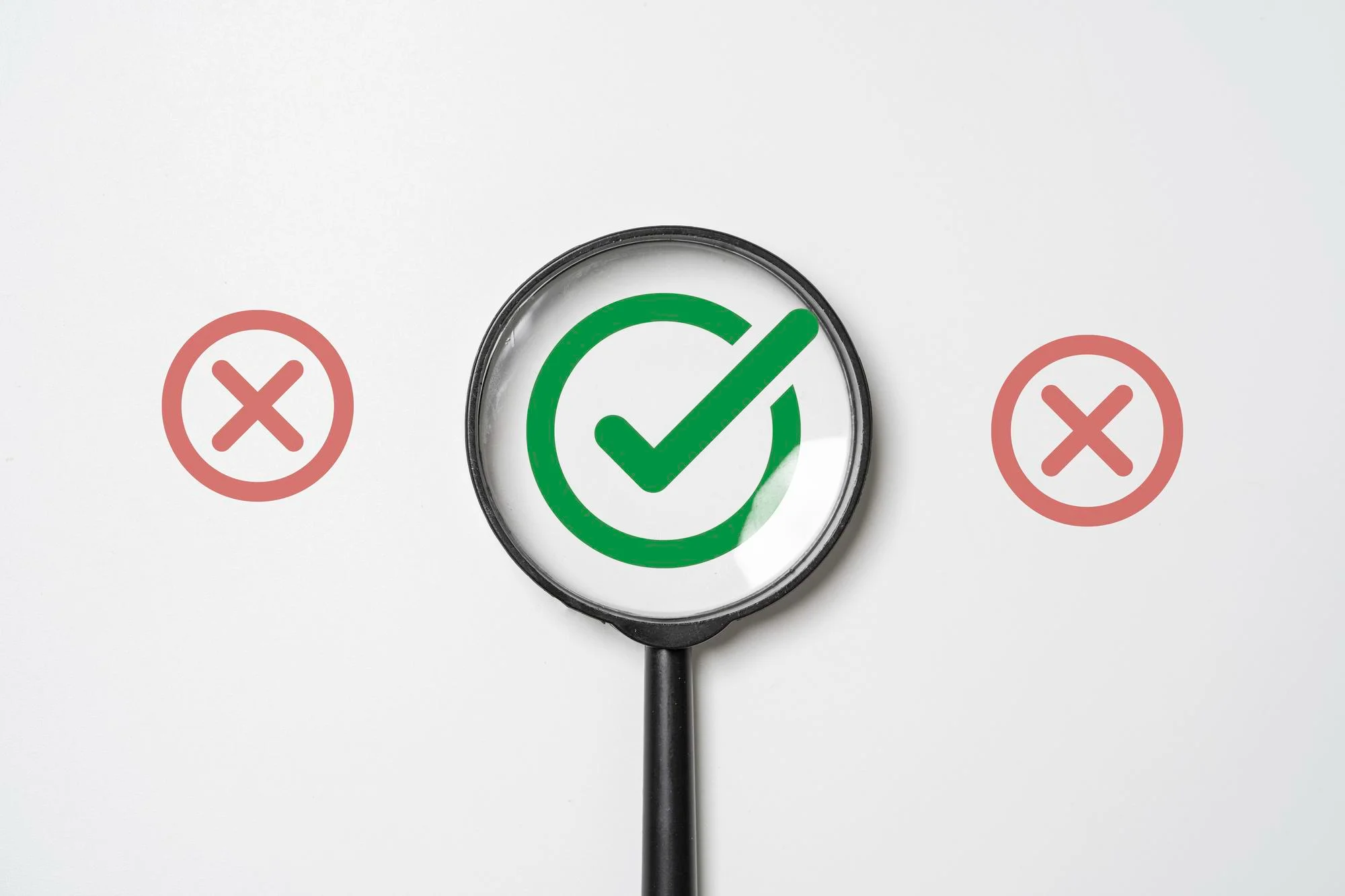 Magnifying glass focusing on a green checkmark check selection choice